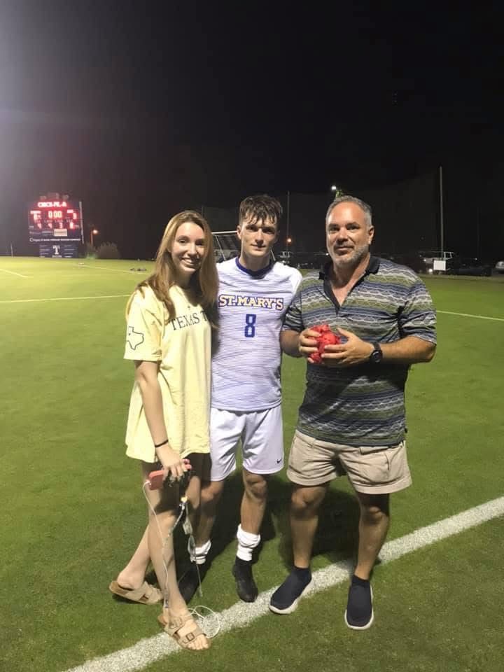 Enrique in his St. Mary's soccer uniform with his family